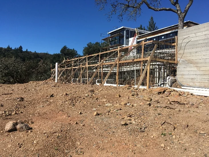 Structural supports under construction for a hillside pool