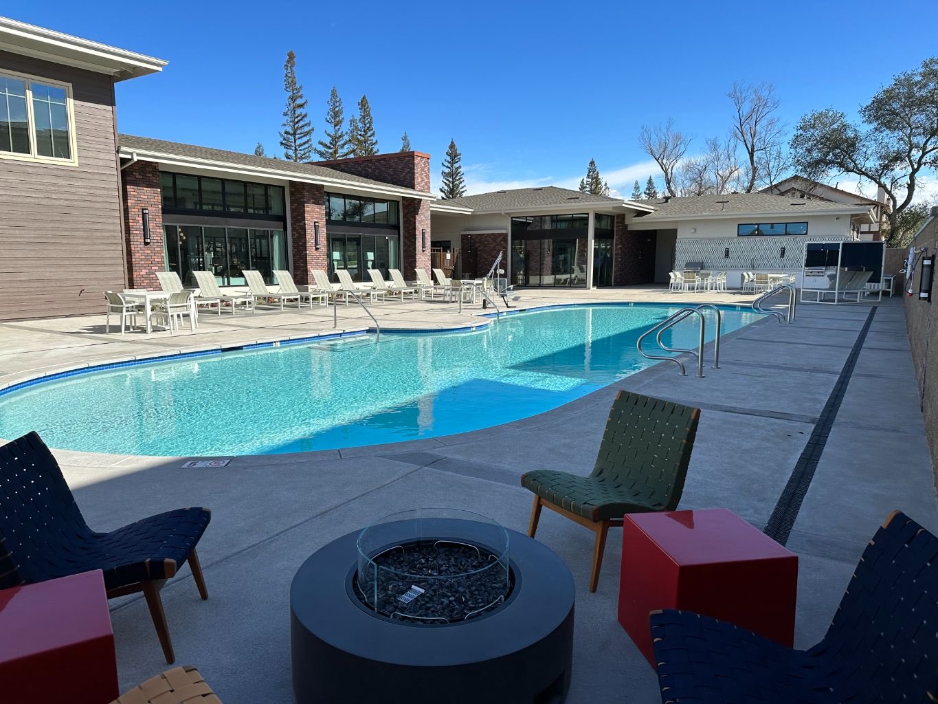 Commercial pool under construction with safety fencing and equipment pad