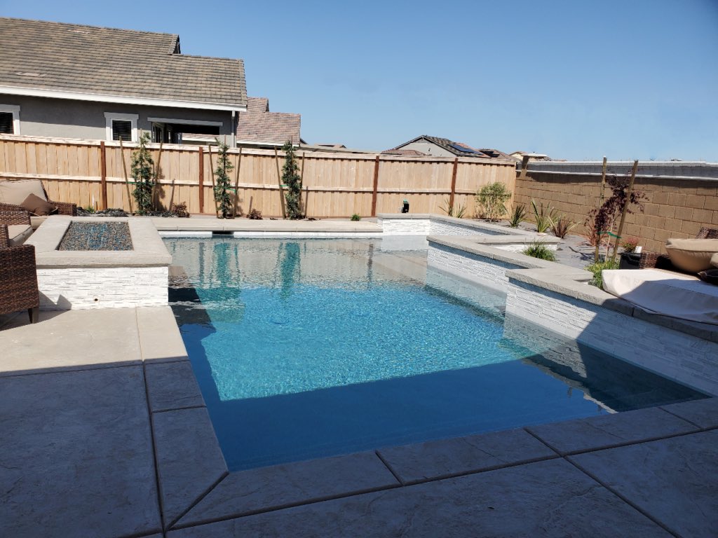 Rectangular pool with fire pit and covered patio