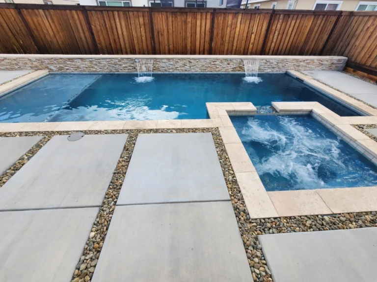 Rectangular pool with spa and sheer descent water features